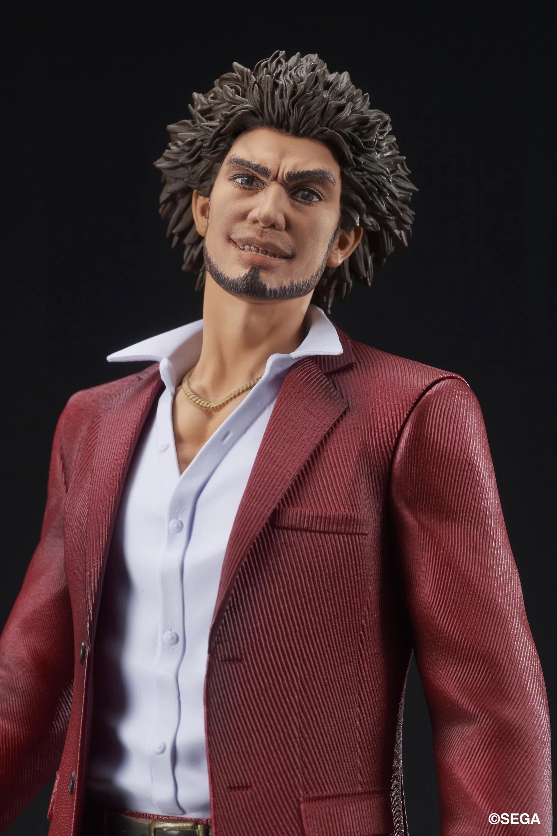 A close-up of the Ichiban Kasuga figure's face, featuring his stylized, confident smile and iconic hairstyle.
