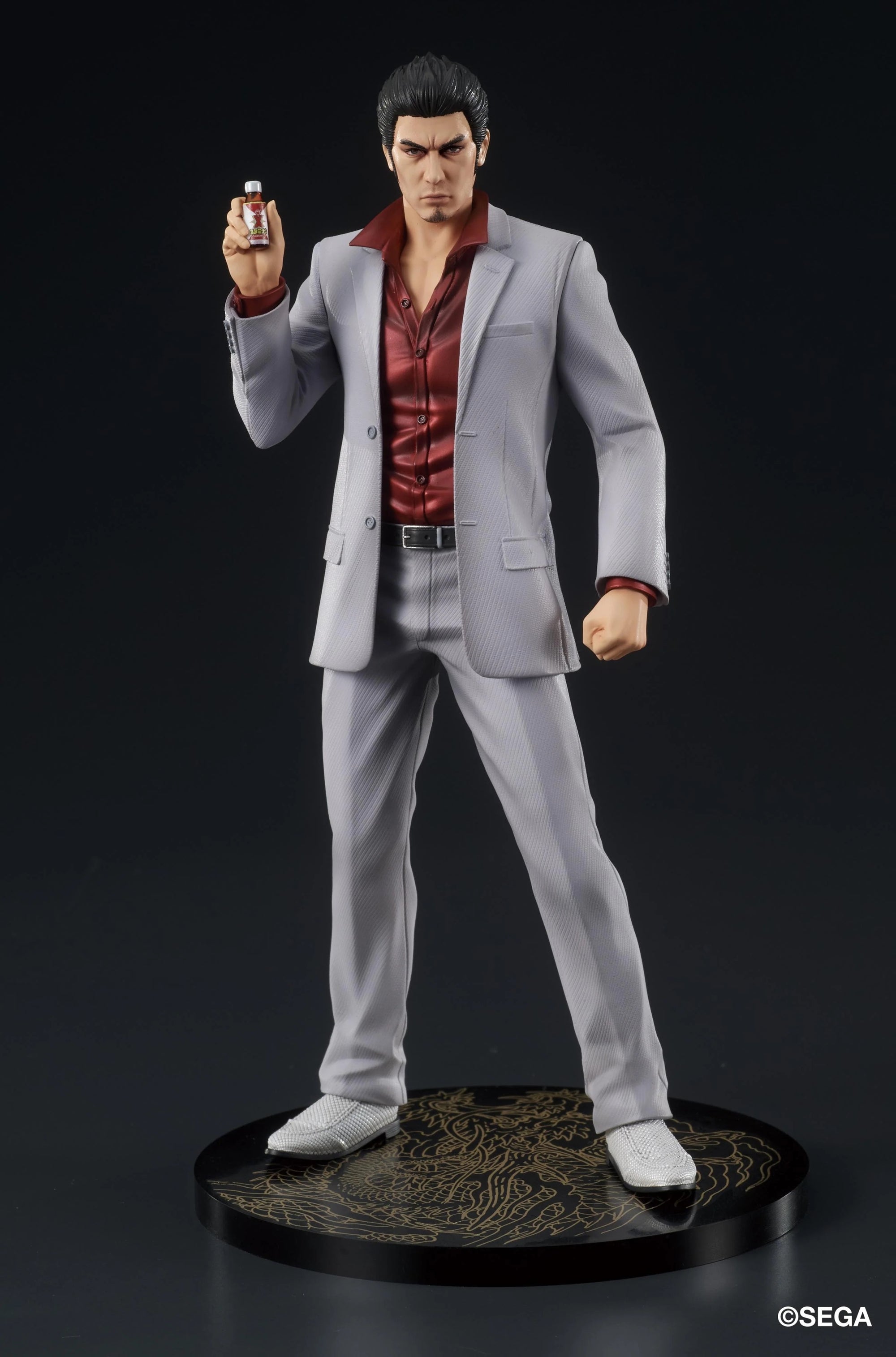 The Kazuma Kiryu figure posed holding the Staminan X recovery drink accessory, ready for a fight.