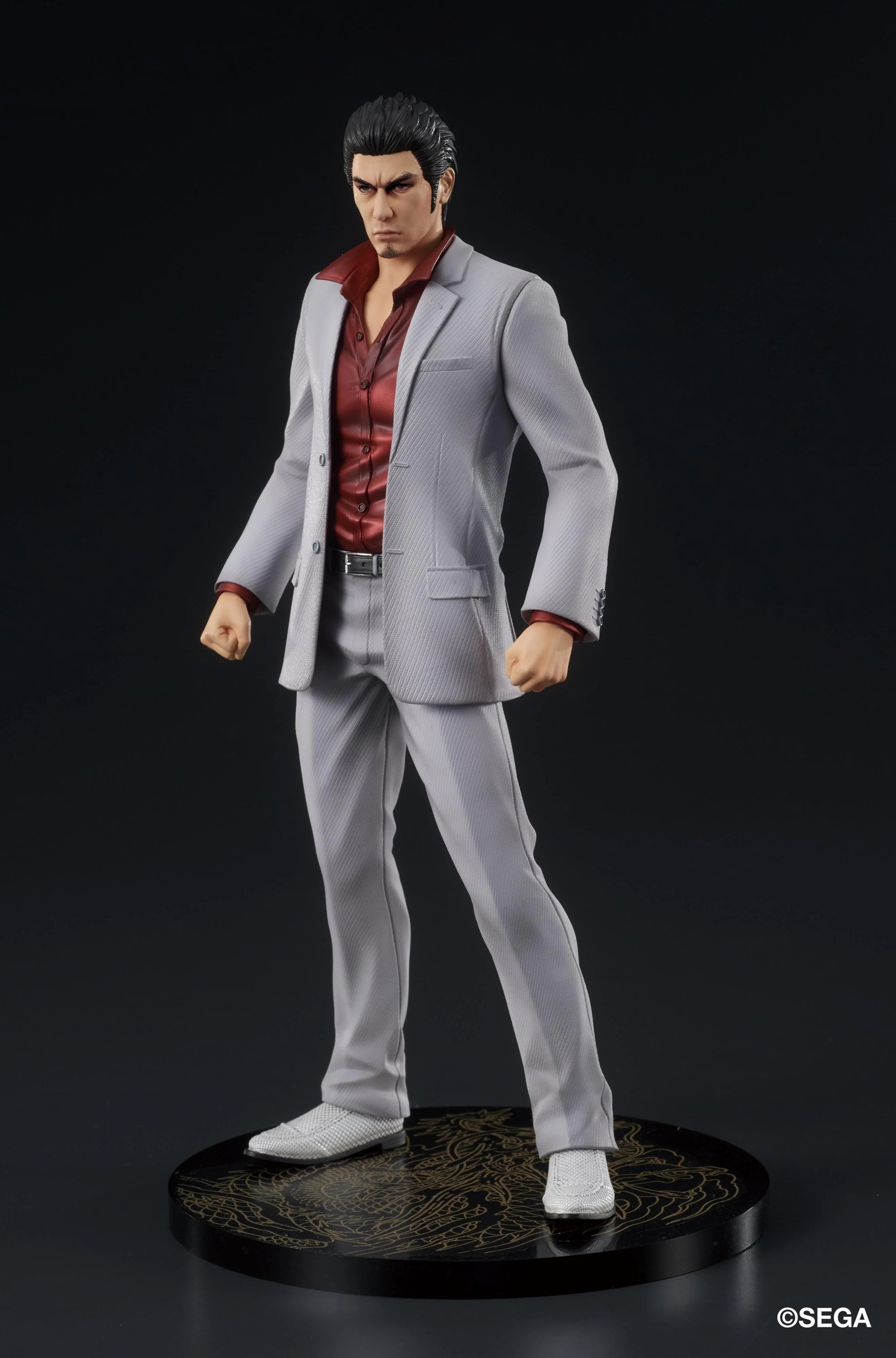 A three-quarter front view of the Kazuma Kiryu figure, showcasing his determined expression and the sharp tailoring of his gray suit.