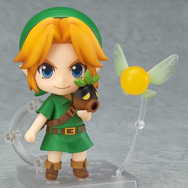 Nendoroid Link figure posed holding the Deku Mask accessory, with his fairy companion, Tatl, attached via a clear stand.