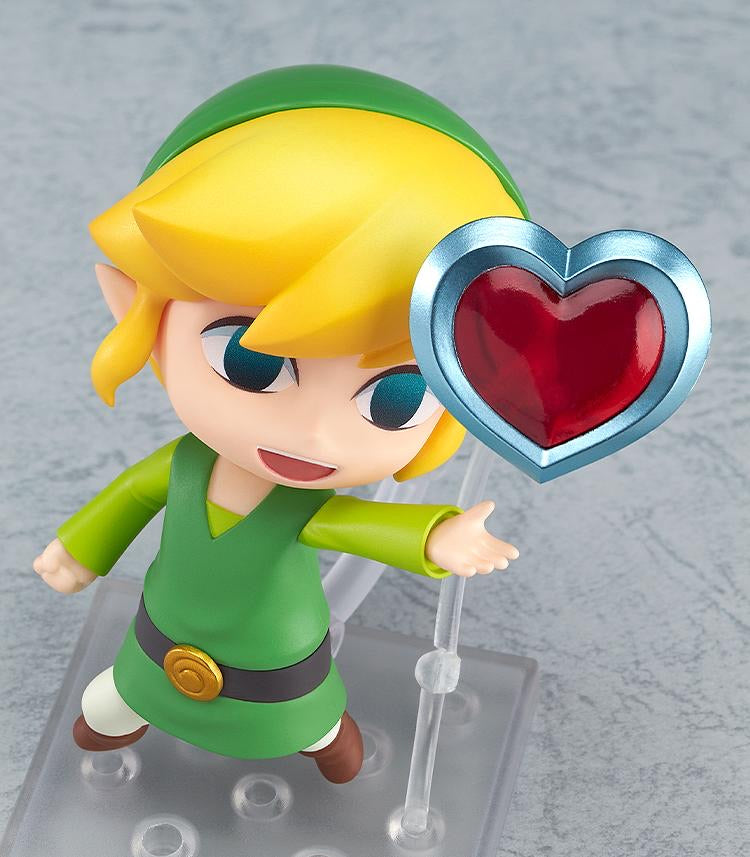 The Nendoroid Link figure in a happy pose, reaching out towards the included Heart Container accessory.