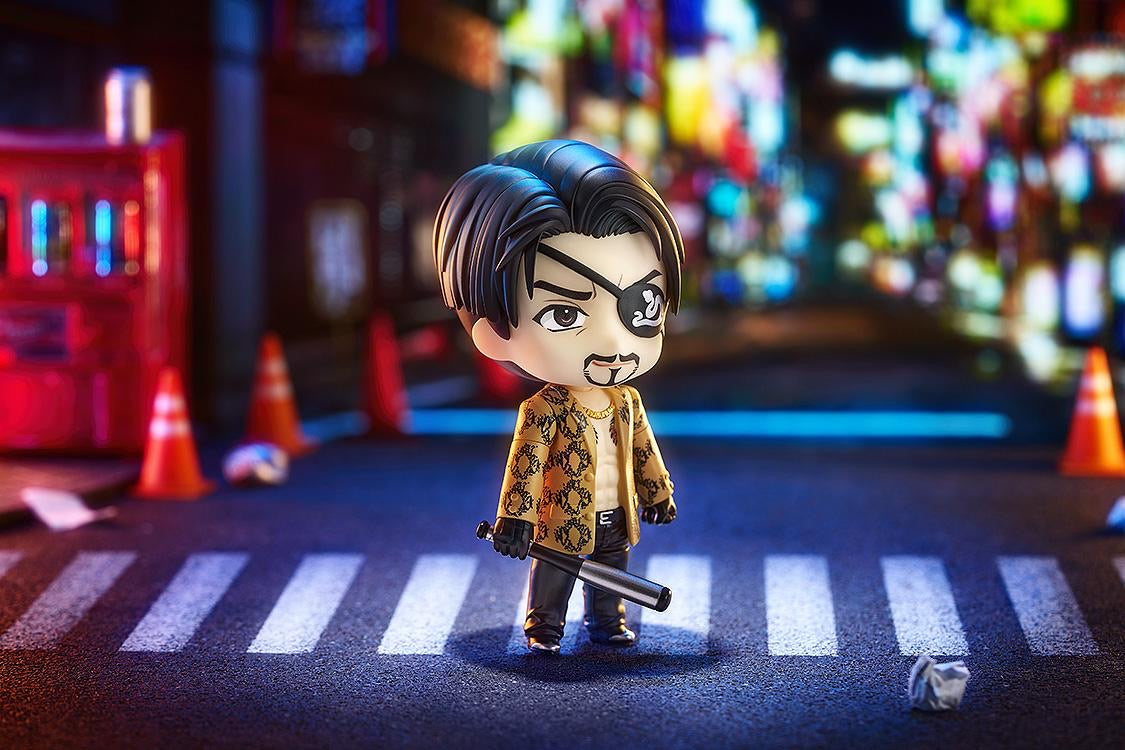 Majima Nendoroid figure standing in a dimly lit street diorama, holding the metal bat, capturing a moody Yakuza atmosphere.