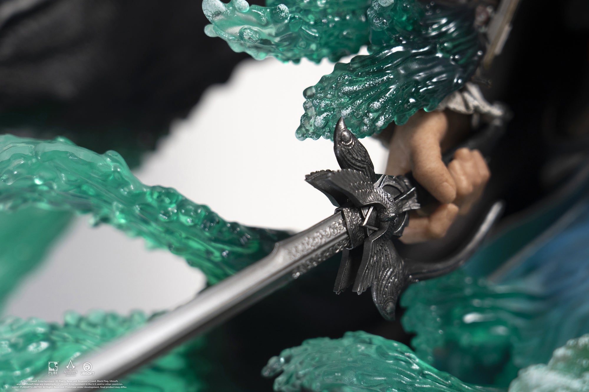 A detailed shot of the hilt of Edward Kenway's saber on the statue, highlighting the intricate silver and black design.