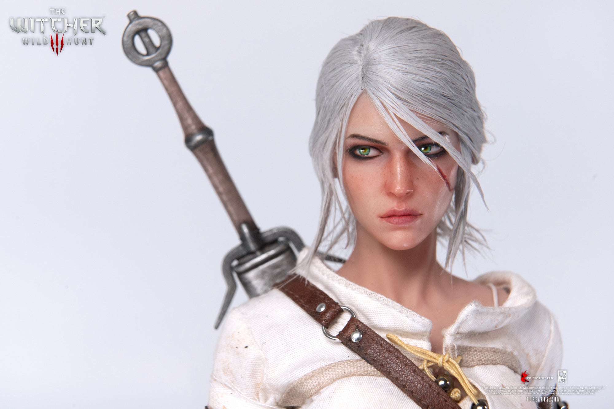 A close-up of the Ciri figure's face, highlighting the rooted white hair, scarred cheek, and intense green eyes.