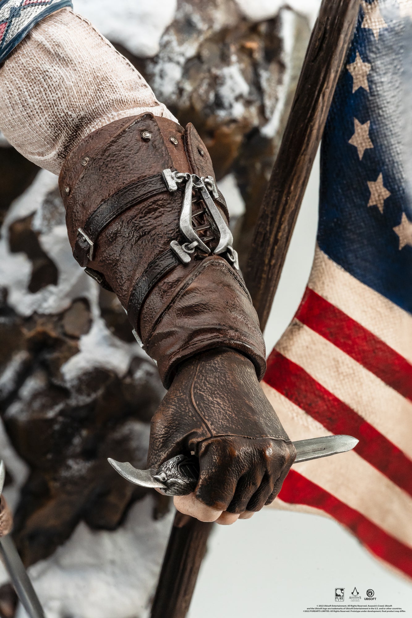 A detailed close-up of Connor’s forearm from the statue, showing his hand gripping his hidden blade and the intricate leather arm guard.