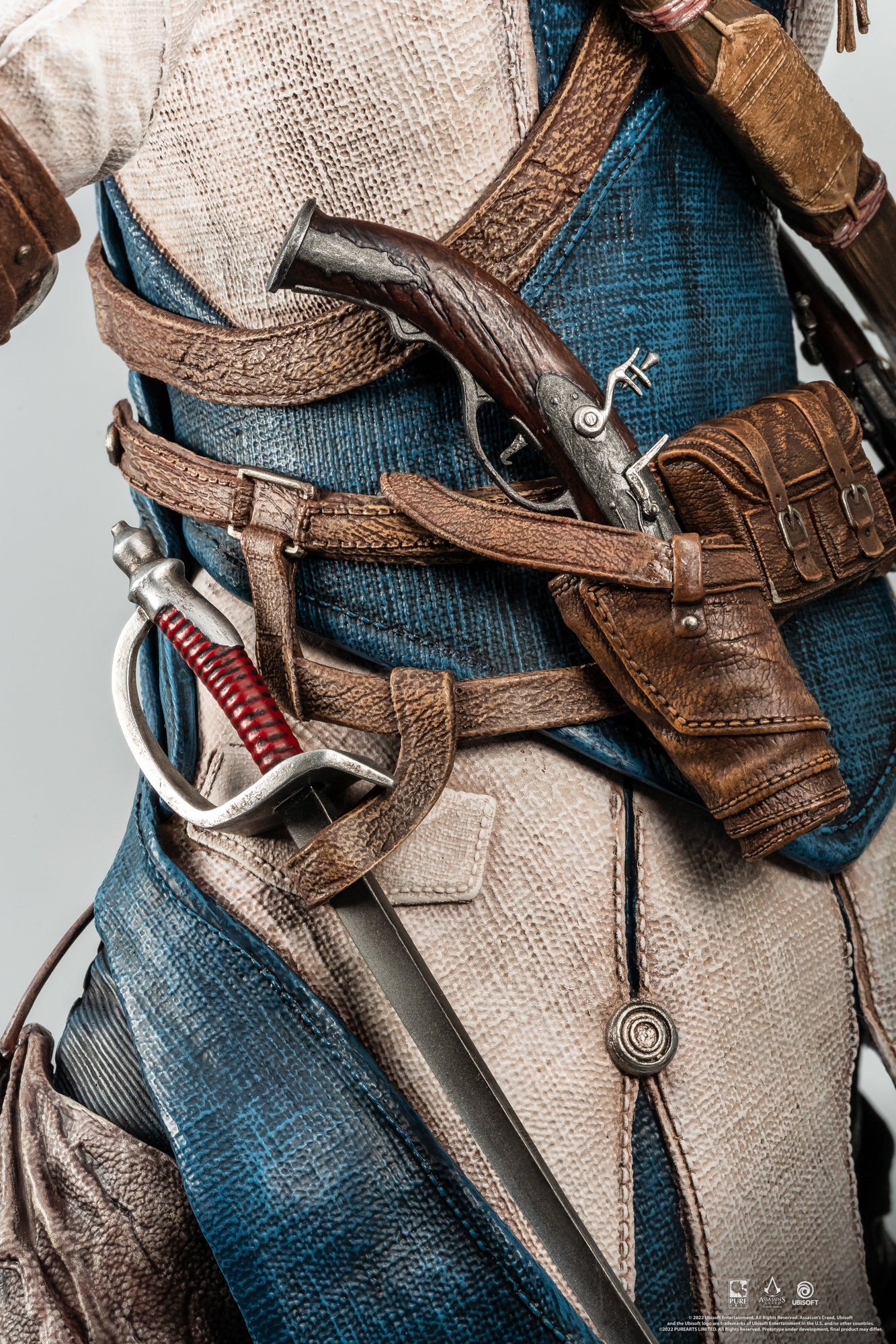A close-up shot of the weapons on the Animus Connor statue, showing his detailed flintlock pistol and saber holstered on his belt.