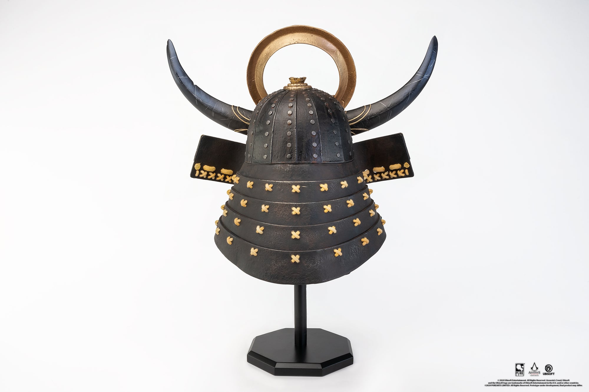 Back view of the complete PureArts Yasuke helmet replica on its display stand, showcasing the black horns, gold crest, and the studded helmet design.
