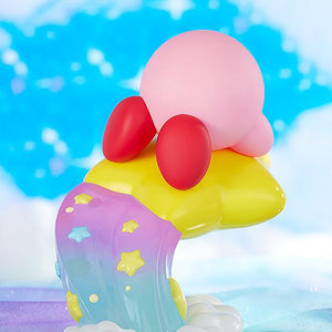 Rear scenic angle of the Kirby figure highlighting the colorful pastel rainbow jet stream base within a fluffy blue and white cloud diorama.