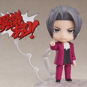 Miles Edgeworth Nendoroid figure pointing forward with Japanese Objection text speech bubble on white background.