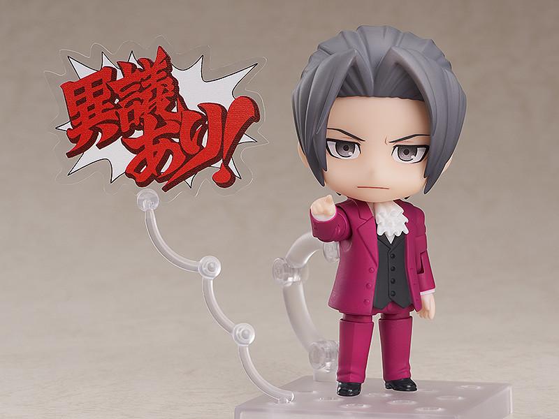 Miles Edgeworth Nendoroid figure pointing forward with Japanese Objection text speech bubble on white background.