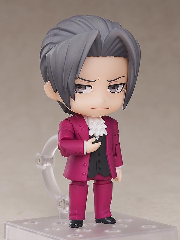 Ace Attorney Miles Edgeworth Nendoroid figure displaying smug smile faceplate with open hand gesture.