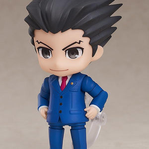 Phoenix Wright Nendoroid figure holding green Magatama accessory on clear display stand.