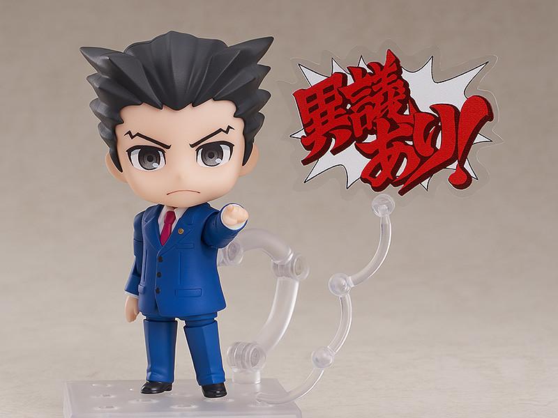 Phoenix Wright Nendoroid figure pointing finger with Japanese Objection text plate on clear stand.