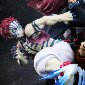 Close-up shot of Upper Moon Three Akaza with blue body tattoos delivering a kick with martial arts splash effect
