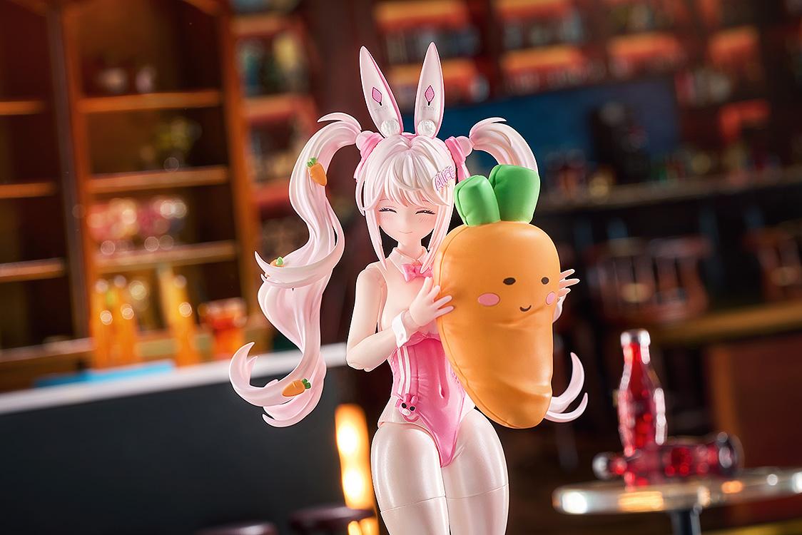Close-up of the Alice: Wonderland Bunny figure hugging a plush carrot accessory with a happy facial expression.