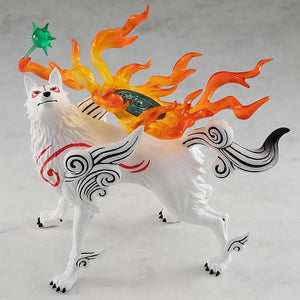 Elevated three-quarter side view of the Amaterasu plastic figure, showcasing the vibrant translucent orange flame effects and the green circular Divine Instrument reflector on her back.