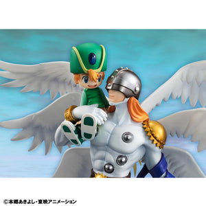 Detailed close-up of Angemon holding a smiling T.K. Takaishi, featuring the Holy Ring and silver helmet.