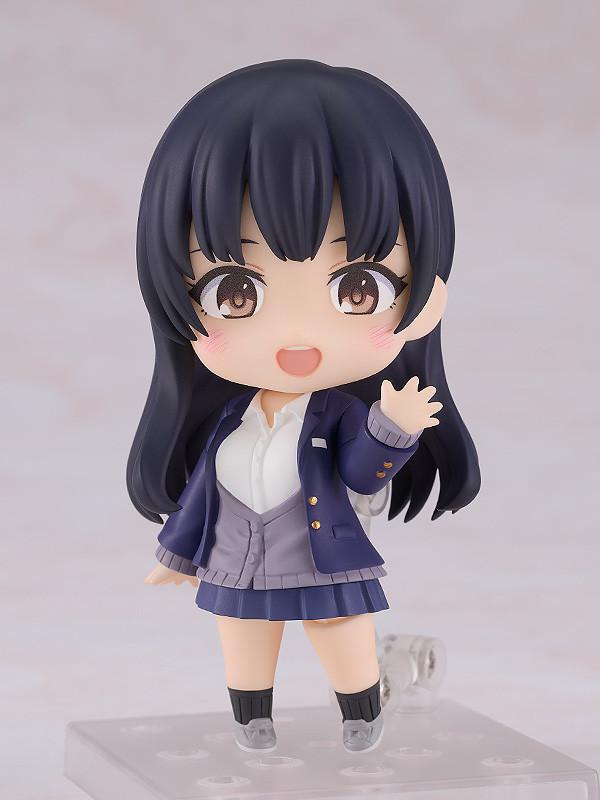 Anna Yamada Nendoroid in a cheerful waving pose on a clear display stand, wearing her signature blue school blazer and grey cardigan.