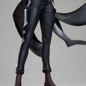 Close-up detail shot focusing on the tailored black trousers, high-heeled dark brown boots, and patterned waistcoat of the Joker scale figure.
