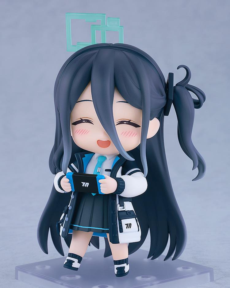 Side angle of the Aris Tendou Nendoroid figure with a happy blushing face, holding a blue and black gaming console accessory.