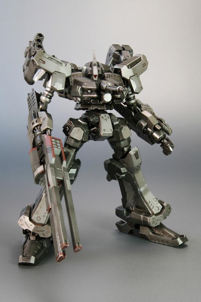 Low angle studio front view of the bipedal Crest CR-C90U3 model kit from Armored Core Last Raven, highlighting its wide stance, heavy shoulder pads, and linear weapons.