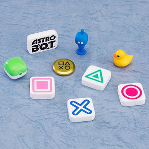 A group of random surprise accessories from the set, including PlayStation button symbols (Square, Triangle, Cross, Circle), a gold coin, a yellow rubber duck, and an Astro Bot logo piece.