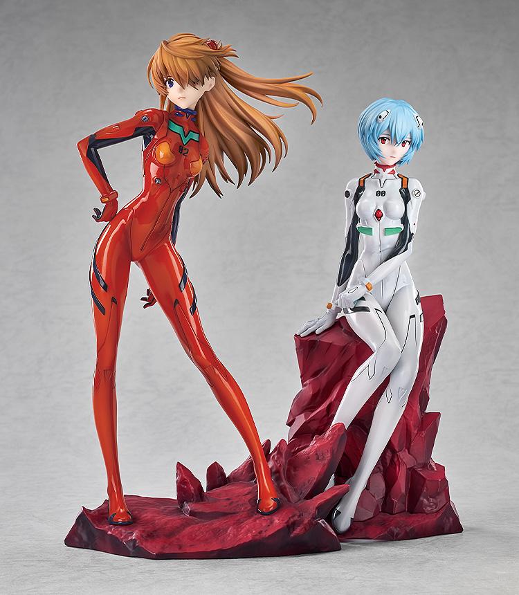 Display showing the Asuka Shikinami Langley figure standing next to a seated Rei Ayanami figure on a red rocky base.