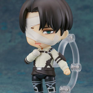 Nendoroid Levi figure using the downcast face plate and posed with his hand near his chest.
