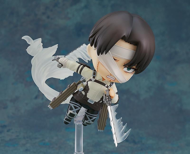 Nendoroid Levi figure displayed using the smoke effect parts to show him soaring through the air with his Vertical Maneuvering Equipment.