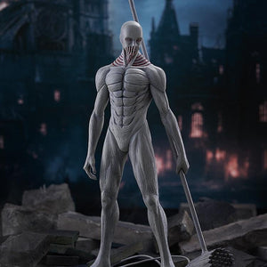 War Hammer Titan Pop Up Parade L figure standing in a destroyed city background scene, showcasing its muscular form and weapon.