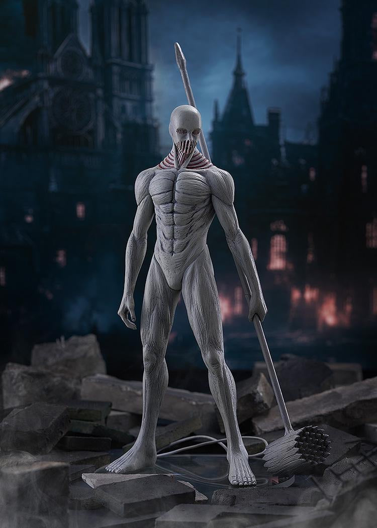 War Hammer Titan Pop Up Parade L figure standing in a destroyed city background scene, showcasing its muscular form and weapon.