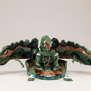 Unfolded Biollante playset with mouth open roaring, vine tendrils, and miniature maser tanks at the base.