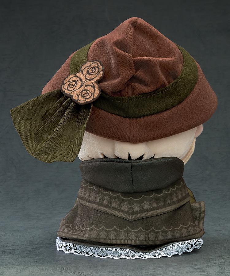 Rear view of The Doll plushie from Bloodborne, highlighting the green ribbon, rose accents on the bonnet, and lace trim on the capelet.