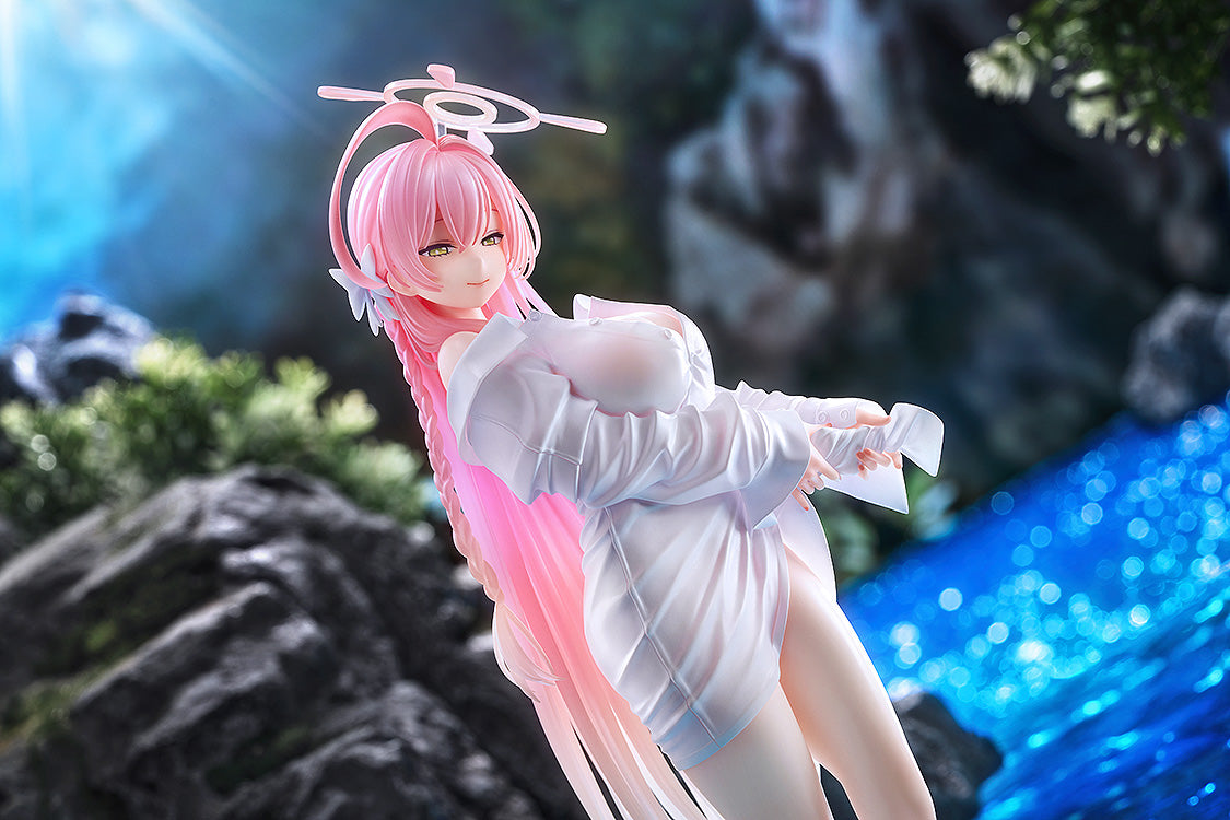 Low side-angle shot of the Hanako Memorial Lobby 1/7 scale figure standing in front of vibrant blue water and rocky terrain.