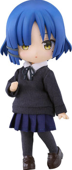 Full shot of the Bocchi the Rock! Ryo Yamada Nendoroid Doll figure featuring her signature short blue hair, grey hair clip, yellow eyes, and beauty mark, wearing a fabric school uniform against a pure white background.
