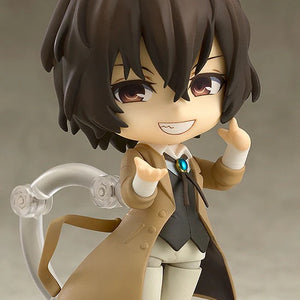 Nendoroid Osamu Dazai figure with the grinning face plate, posed with a relaxed hand gesture, highlighting his cheerful expression.