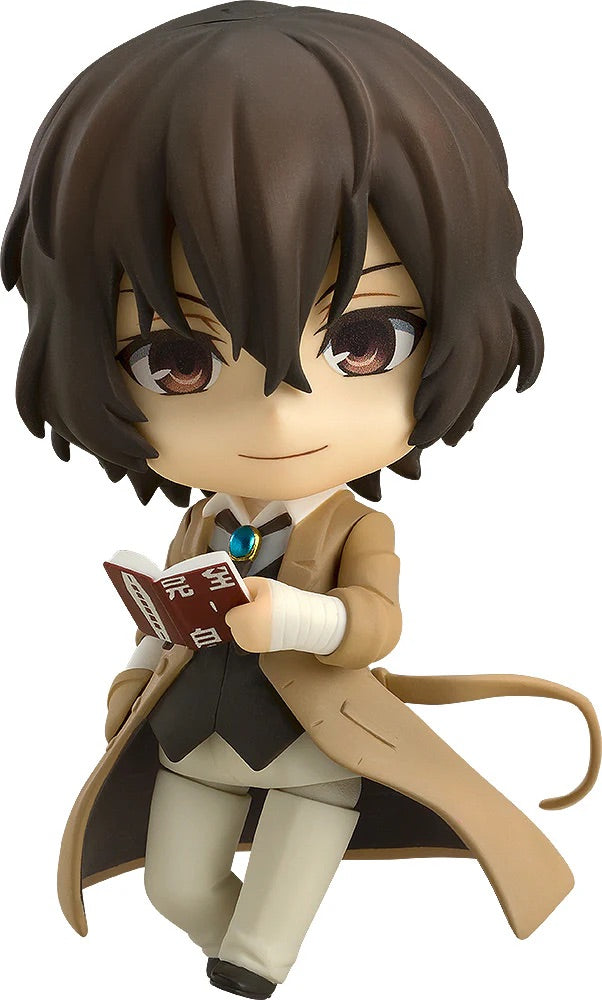 Main image of the Bungo Stray Dogs Nendoroid Osamu Dazai figure, wearing his trench coat and holding his favorite book, "A Guide to Suicide."