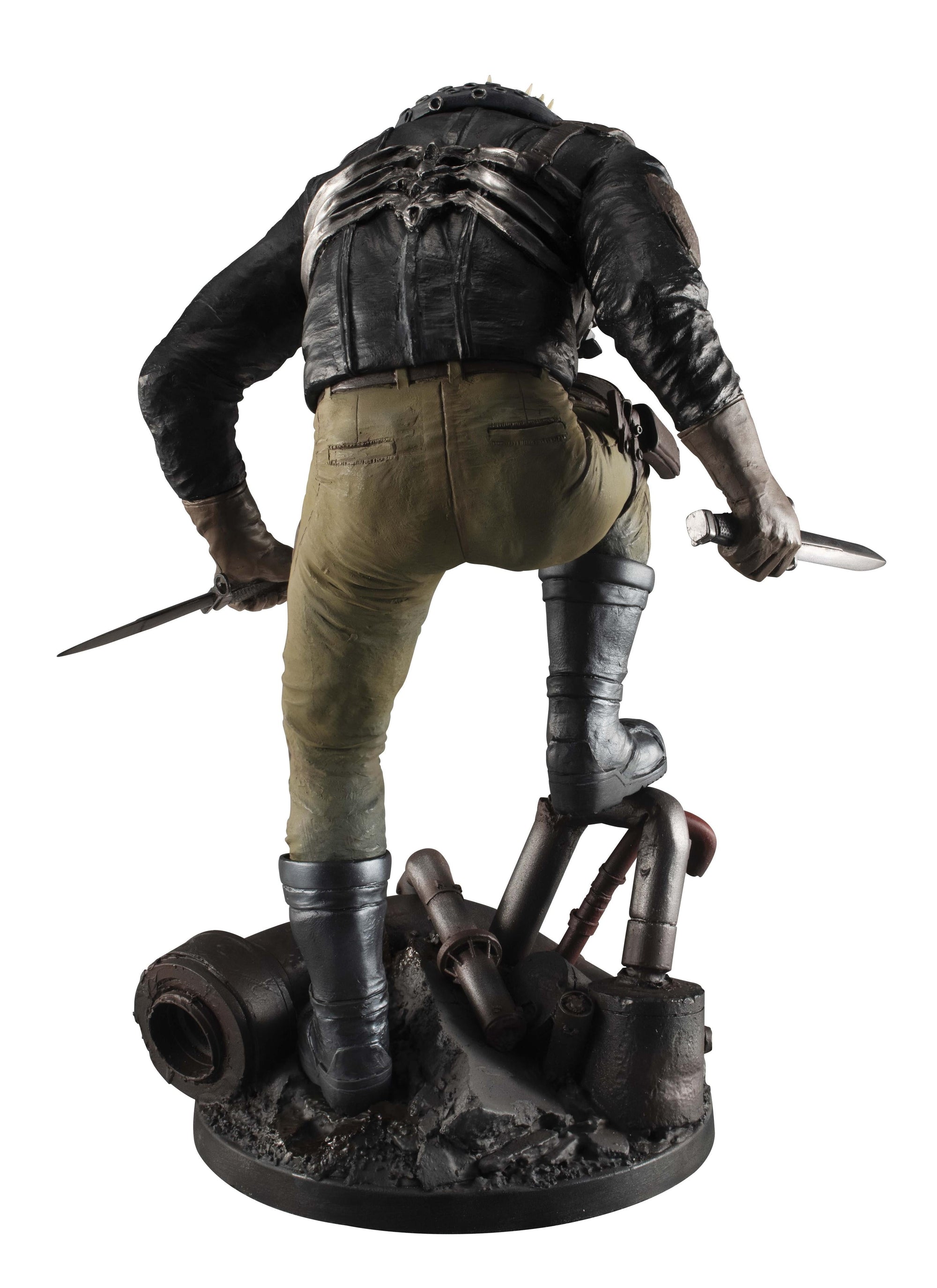 Direct rear view of the Caiman collectible figure showcasing the detailed combat gear, tactical pants, and spine-like armor plates.