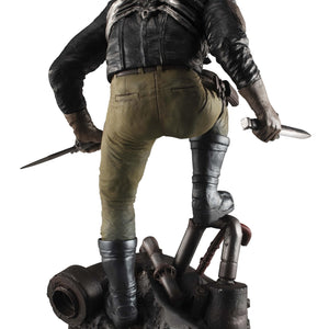 Direct rear view of the Caiman collectible figure showcasing the detailed combat gear, tactical pants, and spine-like armor plates.