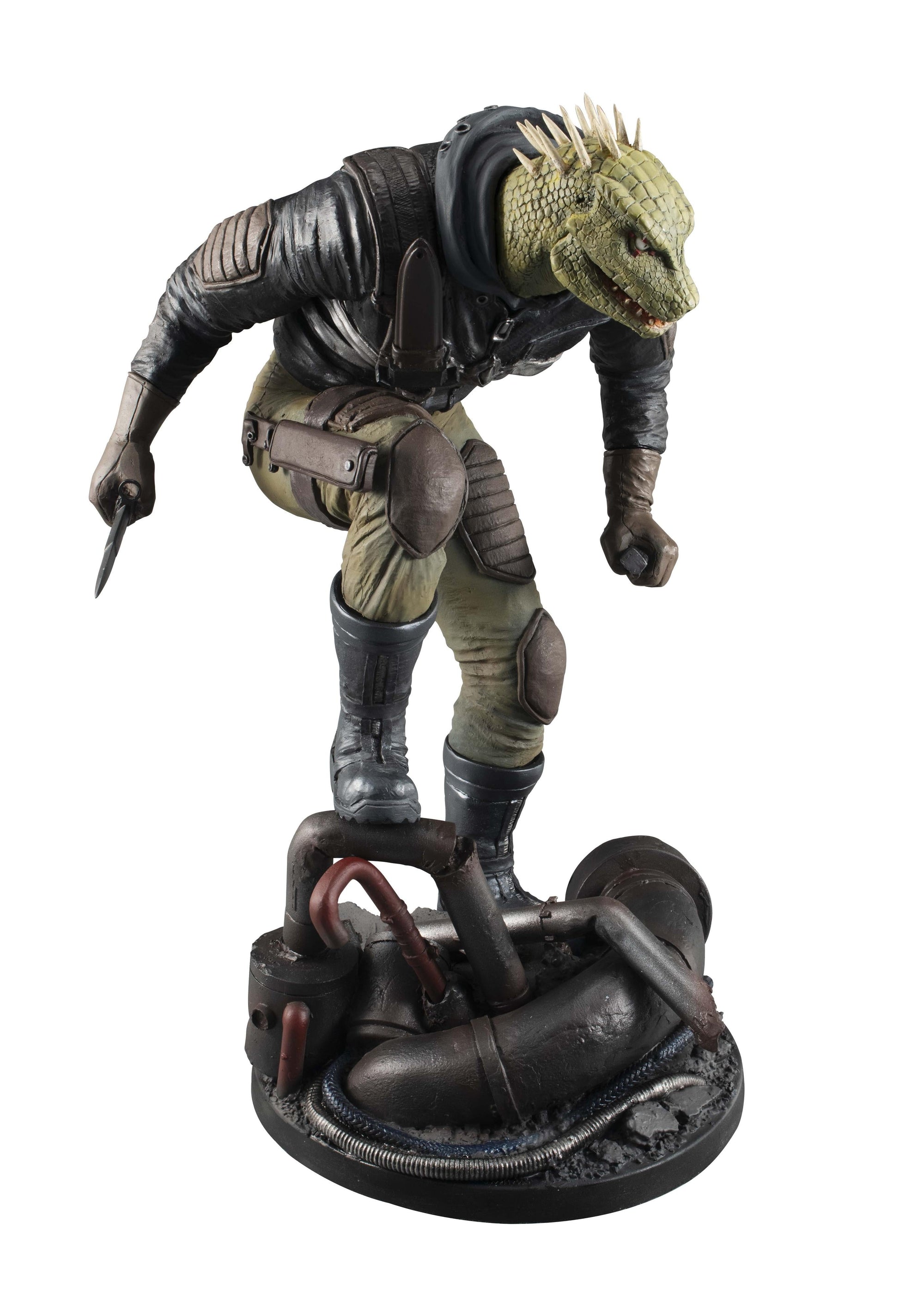 Three-quarter front view of the Caiman figure crouching atop a highly detailed industrial pipe diorama base.