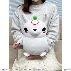 Size reference shot showing a person holding the 10.82-inch medium size Okami Amaterasu MochiKawa plush toy in their lap to demonstrate its scale.