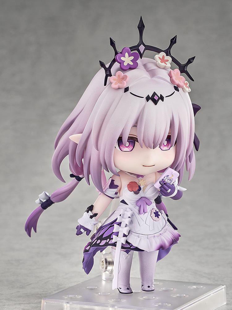 Castorice Nendoroid figure in a cute standing pose with a pleasant smile, holding a tiny lavender smartphone accessory up to her face.