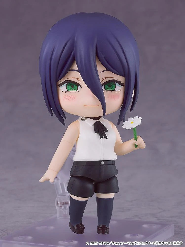 Nendoroid Reze figure with the smiling face plate, holding a white flower accessory and wearing her white sleeveless shirt and black shorts.