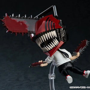 Dynamic action pose of the Nendoroid Denji figure in his transformed state, showing him flying through the air with the chainsaw arms.