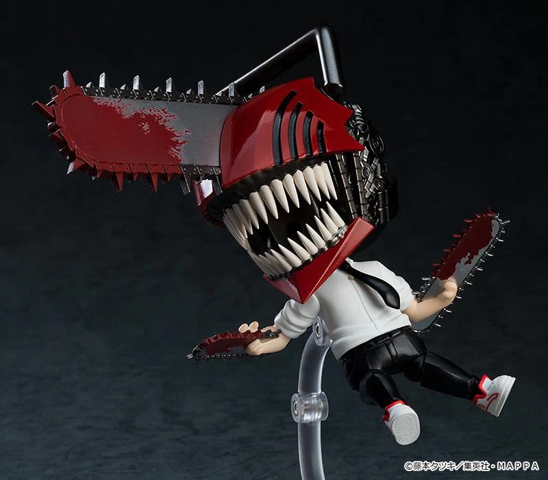Dynamic action pose of the Nendoroid Denji figure in his transformed state, showing him flying through the air with the chainsaw arms.