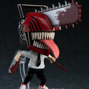 Nendoroid Denji figure in his transformed state, showing the articulated jaw, hanging tongue, and interchangeable chainsaw arms.