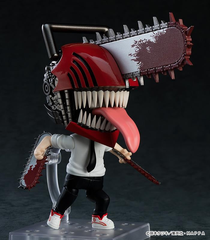 Nendoroid Denji figure in his transformed state, showing the articulated jaw, hanging tongue, and interchangeable chainsaw arms.
