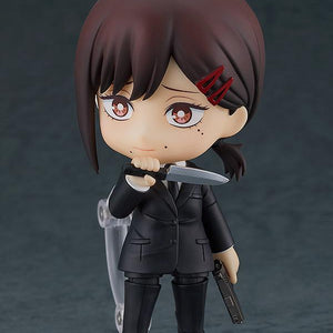 Front view of Nendoroid Kobeni holding a knife in her right hand near her chin and a gun in her left hand, wearing her Public Safety uniform.