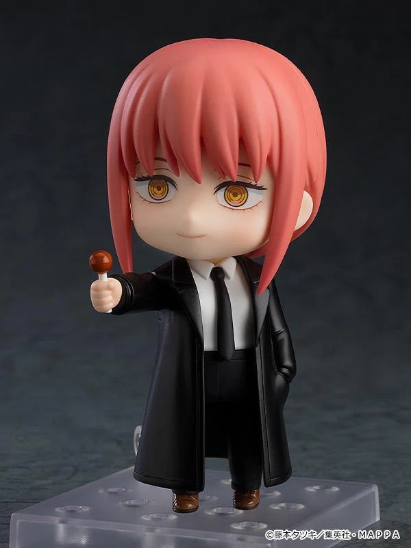 Nendoroid Makima figure wearing the trench coat optional part, holding the lollipop accessory with a smiling face plate.