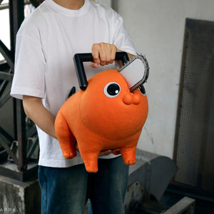 Person carrying the Pochita life-size plush doll using its top black chainsaw handle.